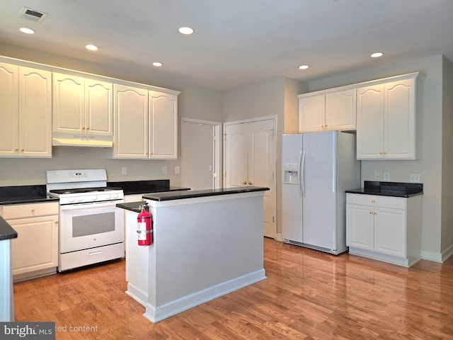 10 Honeyflower, Bordentown, NJ 08620 - kitchen featuring white appliances, under cabinet range hood, dark countertops, white cabinetry, and recessed lighting