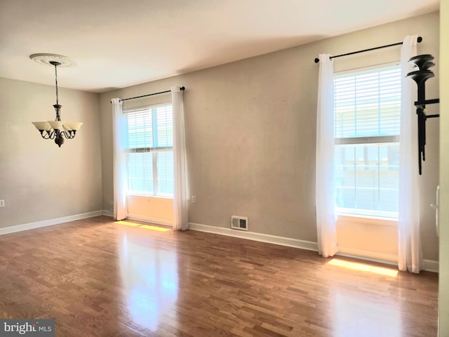 10 Honeyflower, Bordentown, NJ 08620 - spare room with wood finished floors, a chandelier, and baseboards