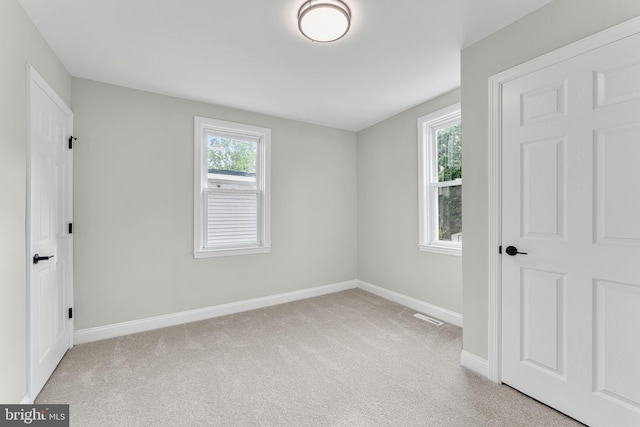 59 Jarvis St, Pemberton, NJ 08068 - unfurnished bedroom featuring baseboards, multiple windows, and light carpet