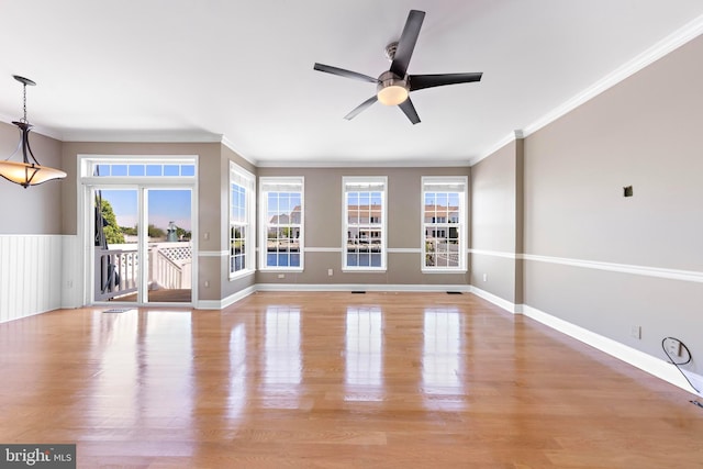 14 Osprey Ln, Bayville, NJ 08721 - unfurnished living room featuring plenty of natural light, ceiling fan, light wood-style floors, and crown molding