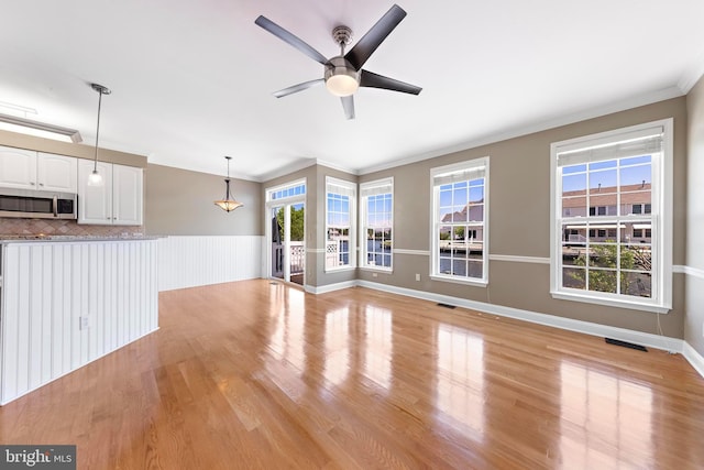 14 Osprey Ln, Bayville, NJ 08721 - unfurnished living room featuring ceiling fan, ornamental molding, and light wood-style floors