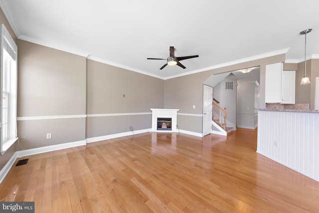 14 Osprey Ln, Bayville, NJ 08721 - unfurnished living room featuring ceiling fan, light wood-style flooring, stairs, a glass covered fireplace, and baseboards