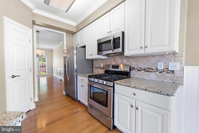 14 Osprey Ln, Bayville, NJ 08721 - kitchen featuring appliances with stainless steel finishes, ornamental molding, white cabinetry, light wood-style floors, and tasteful backsplash
