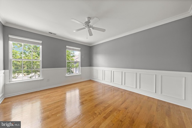 14 Osprey Ln, Bayville, NJ 08721 - spare room featuring wainscoting, ceiling fan, light wood-type flooring, and crown molding