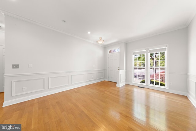 14 Osprey Ln, Bayville, NJ 08721 - unfurnished room featuring crown molding, light wood-style flooring, a decorative wall, wainscoting, and recessed lighting