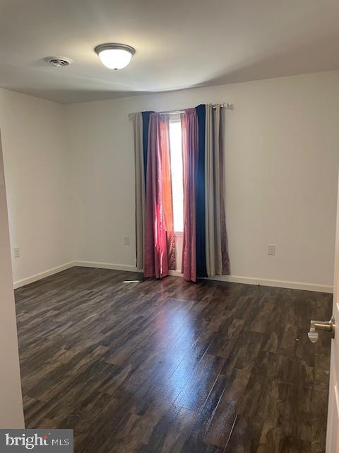 319 Crestmont St, Reading, PA 19611 - empty room with dark wood-style floors and baseboards