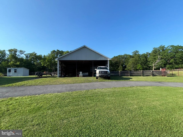 garage with asphalt driveway and a detached carport