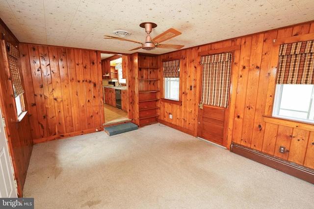 407 Elizabeth St, Georgetown, DE 19947 - carpeted empty room with wood walls, ceiling fan, and baseboards