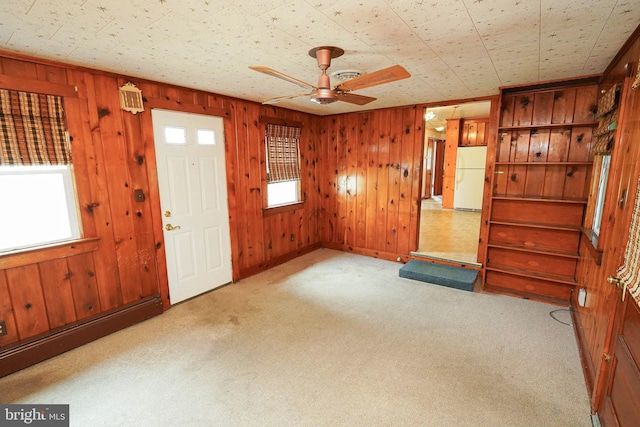 407 Elizabeth St, Georgetown, DE 19947 - carpeted entrance foyer with a ceiling fan, plenty of natural light, and wooden walls