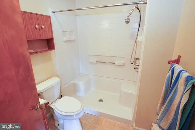 407 Elizabeth St, Georgetown, DE 19947 - full bathroom featuring a shower, toilet, and tile patterned floors