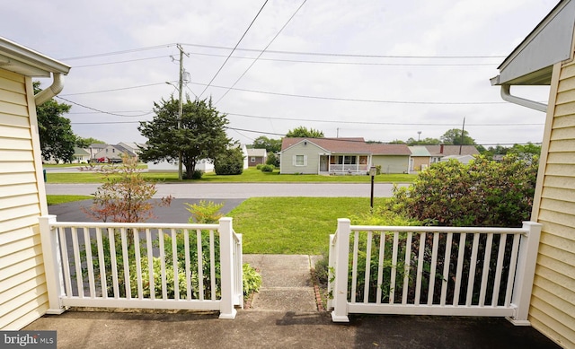 407 Elizabeth St, Georgetown, DE 19947 - view of green lawn with covered porch and a residential view