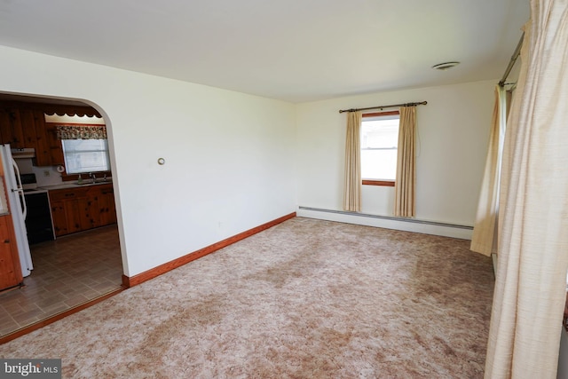407 Elizabeth St, Georgetown, DE 19947 - unfurnished room featuring a baseboard radiator, healthy amount of natural light, baseboards, and arched walkways