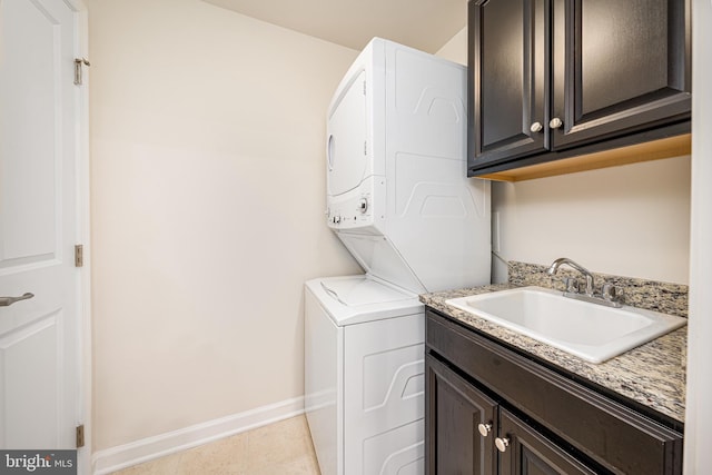 5831 Rochefort St, Ijamsville, MD 21754 - washroom with stacked washer / drying machine, cabinet space, baseboards, and light tile patterned floors