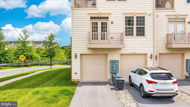 5831 Rochefort St, Ijamsville, MD 21754 - view of front of home with a garage, driveway, a front lawn, and a balcony