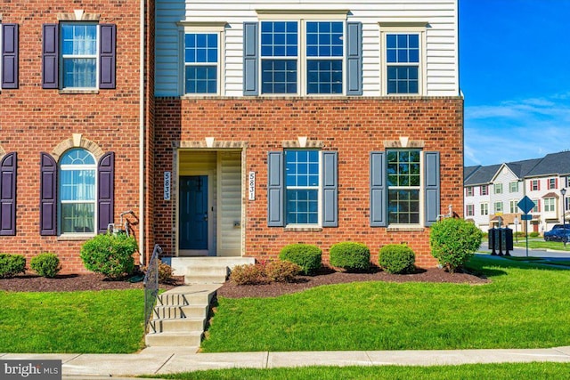5831 Rochefort St, Ijamsville, MD 21754 - view of front facade featuring a front yard and brick siding