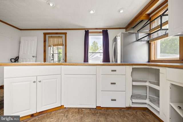 kitchen featuring crown molding, freestanding refrigerator, a sink, white cabinets, and recessed lighting