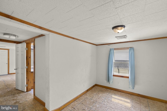 unfurnished room with baseboards and ornamental molding