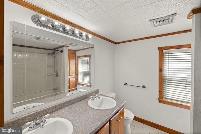 bathroom with toilet, plenty of natural light, tile patterned floors, a shower, and crown molding
