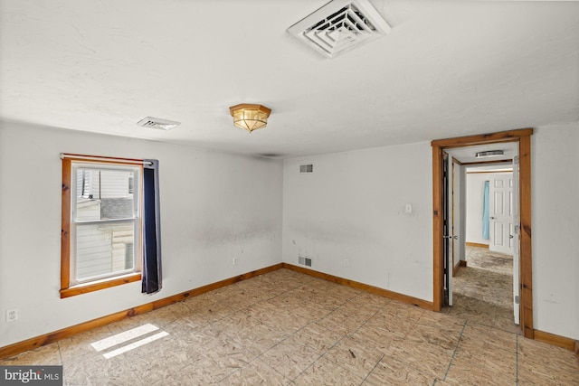 unfurnished room featuring baseboards and a textured ceiling