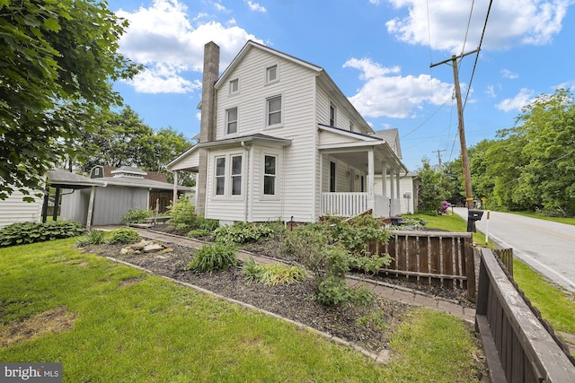 view of side of home featuring a chimney and a porch