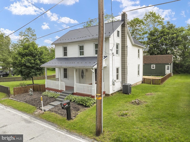 view of front facade featuring covered porch, central AC unit, a chimney, and metal roof