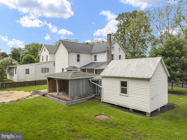 rear view of property with metal roof and a chimney
