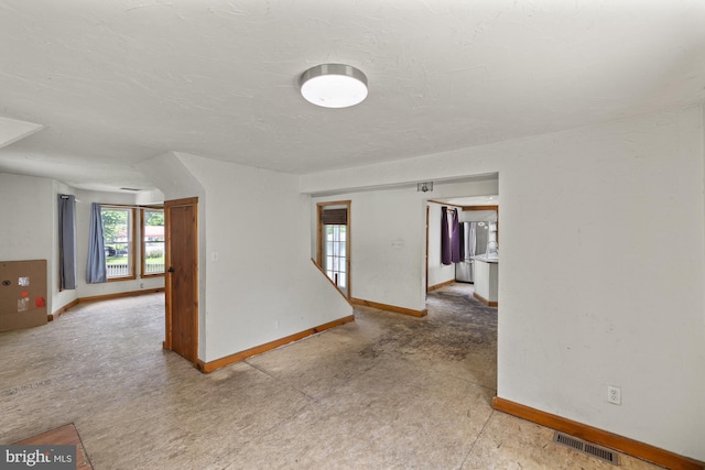 spare room with baseboards