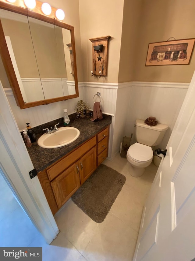 4 Tall Oaks Dr, Pottsville, PA 17901 - bathroom featuring tile patterned floors, vanity, a wainscoted wall, and toilet
