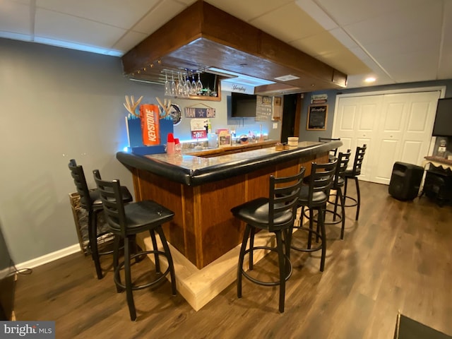 4 Tall Oaks Dr, Pottsville, PA 17901 - indoor bar featuring a paneled ceiling, dark wood-style floors, and baseboards