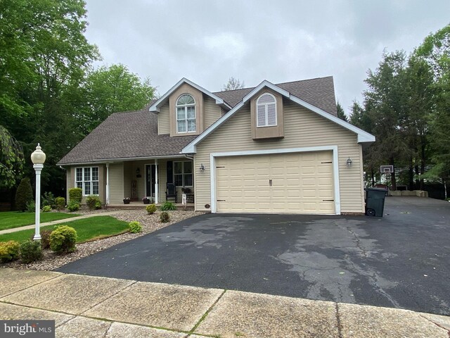 4 Tall Oaks Dr, Pottsville, PA 17901 - traditional home with asphalt driveway, a porch, a shingled roof, an attached garage, and a front yard