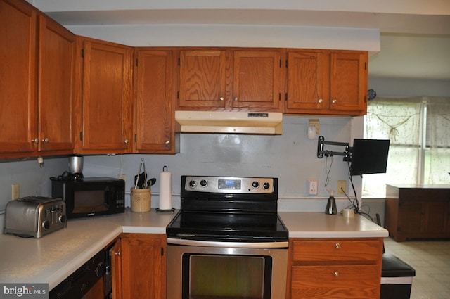 2147 Cloverleaf Rd, Mount Joy, PA 17552 - kitchen featuring under cabinet range hood, stainless steel electric stove, black microwave, light countertops, and brown cabinets