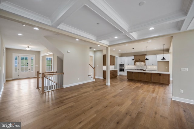 unfurnished living room with coffered ceiling, recessed lighting, light wood-style flooring, ornamental molding, and beamed ceiling