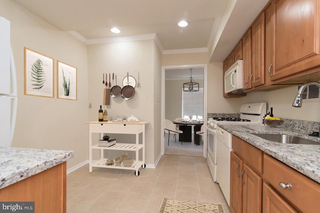 3100 S Manchester St S Unit 915, Falls Church, VA 22044 - kitchen with white appliances, a sink, brown cabinets, crown molding, and light stone countertops
