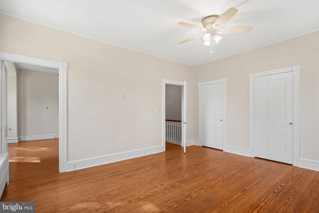 8 E Oak Ave, Moorestown, NJ 08057 - unfurnished bedroom with wood finished floors, baseboards, two closets, and a ceiling fan