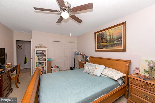 bedroom featuring a closet, light carpet, and a ceiling fan