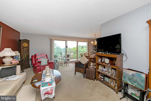 carpeted living area featuring a chandelier