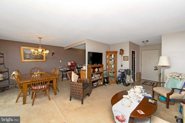 dining room featuring carpet and a chandelier