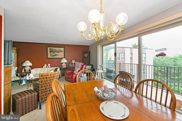 dining space with a chandelier, plenty of natural light, and carpet