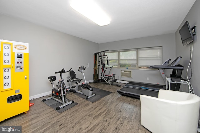 workout area featuring wood finished floors and baseboards