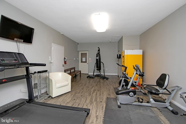 workout room with wood finished floors and baseboards