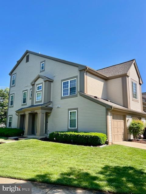 view of front of home with a front lawn, driveway, and an attached garage