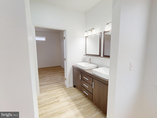 294 Meadow Flower Cir, Bellefonte, PA 16823 - bathroom with wood finished floors, double vanity, and baseboards