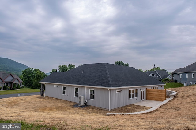294 Meadow Flower Cir, Bellefonte, PA 16823 - back of house with a shingled roof and a mountain view