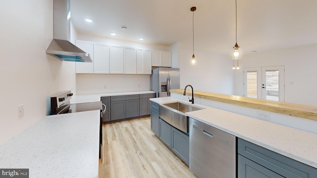 294 Meadow Flower Cir, Bellefonte, PA 16823 - kitchen featuring wall chimney exhaust hood, stainless steel appliances, a sink, light wood-type flooring, and pendant lighting