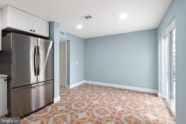 kitchen featuring freestanding refrigerator, white cabinets, baseboards, light countertops, and recessed lighting
