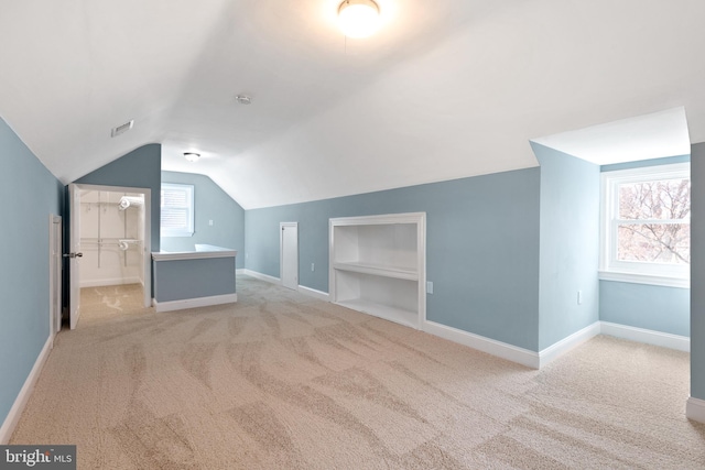 bonus room with carpet flooring, lofted ceiling, built in features, and baseboards