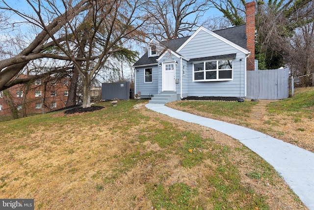bungalow-style home with roof with shingles