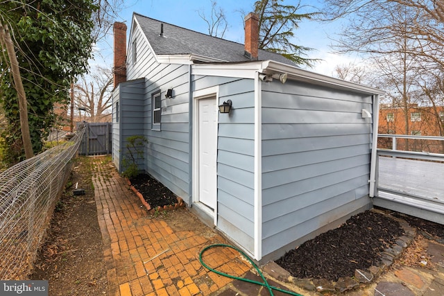 view of outbuilding featuring fence