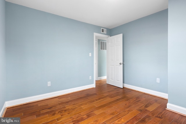 unfurnished room featuring wood finished floors and baseboards