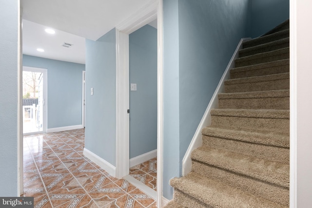 stairs featuring tile patterned flooring, recessed lighting, and baseboards